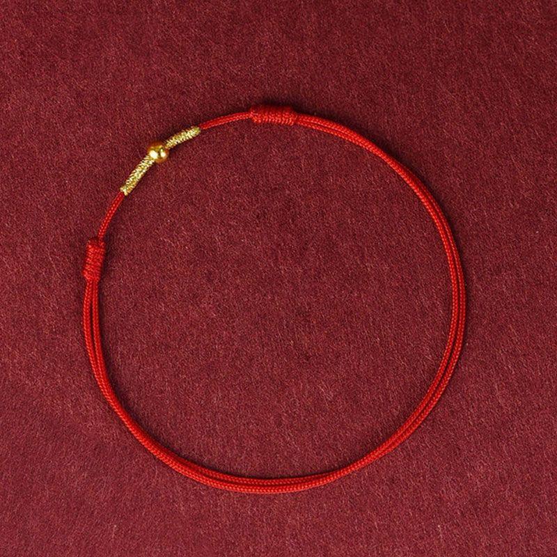 Close-up of gold accent on the red rope, adding a touch of elegance and richness to the design.